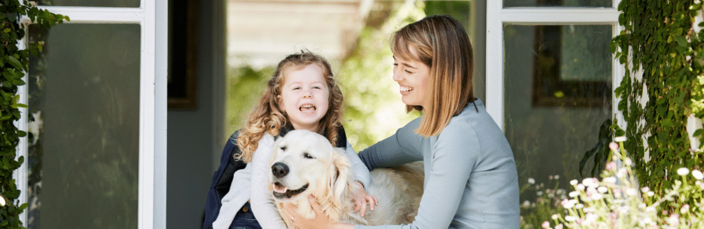 Mom and daughter with dog infront of newly replaced windows