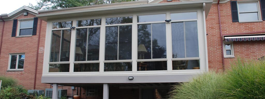 Sunroom between brick home