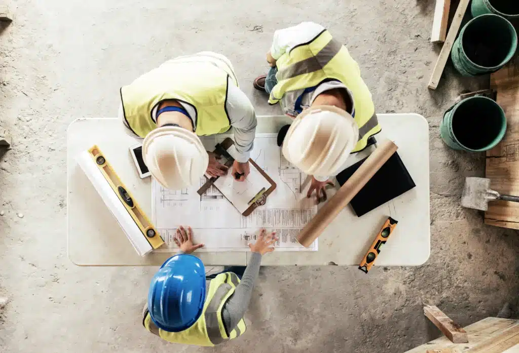 Construction workers reviewing building specifications
