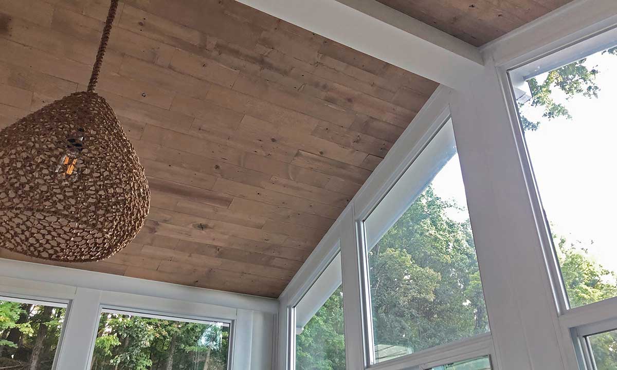 Sunroom with wooden ceiling and windows