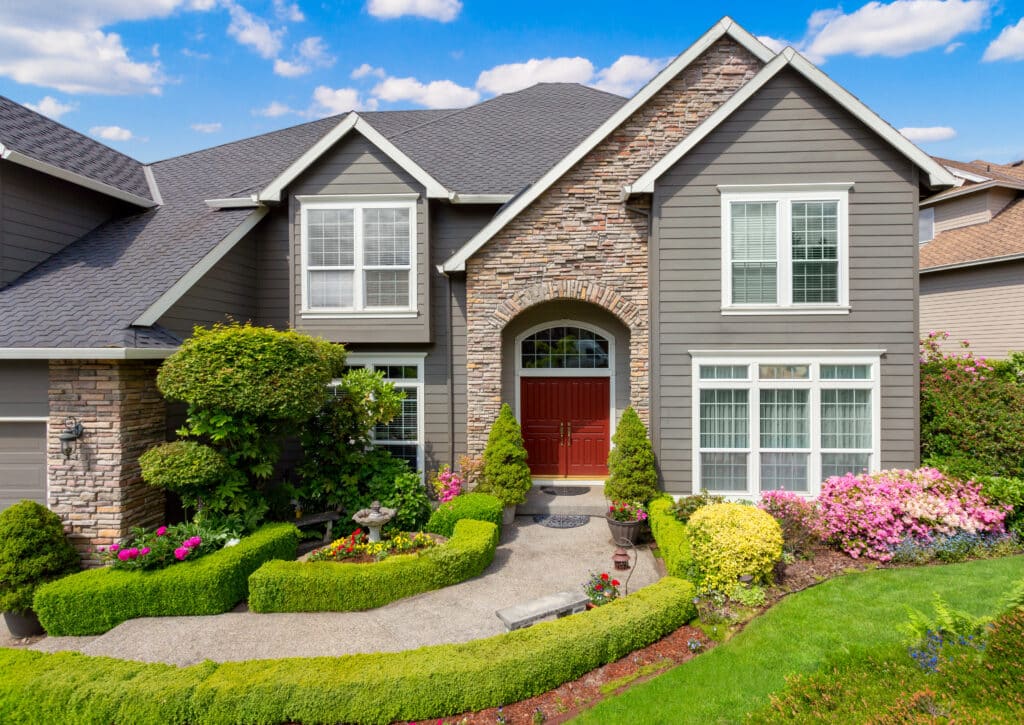 Beautiful New Home Exterior and Landscaping on Sunny Afternoon