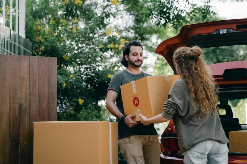 couple moving boxes into home with Joyce manufacturing windows
